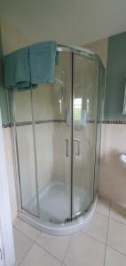 a shower with a glass door in a bathroom at Tully View House in Donegal
