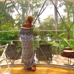 a statue of a woman sitting on a bench at Faith Glamping Dome Costa Rica in Manzanillo