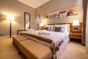 a hotel room with two beds and a mirror at Hotel Elizabeth in Trenčín +73 photos