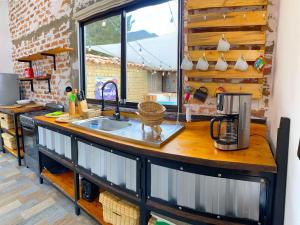a kitchen with a counter top with a sink at Peñavista. in Simijaca