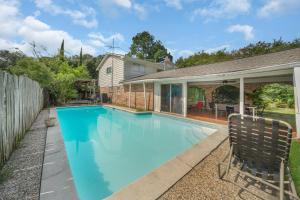 a swimming pool in the backyard of a home at Home for summer with pool, pool table, outdoor kitchen,patio and balcony in Houston