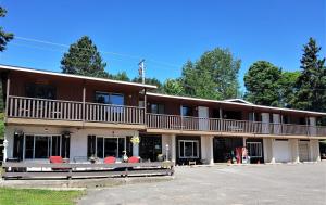 a large building with a balcony on top of it at Lakeshore Motel Ice Lake in Iron River