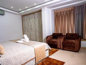 a bedroom with a bed and a chair at Hotel Maghreb El Arabi in Nador