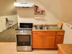 a kitchen with a sink and a stove at Delightful well located one bedroom attic in Elizabeth