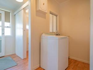 a room with a small white refrigerator in a room at Hosts on the Coast Whiti Delight in Whitianga