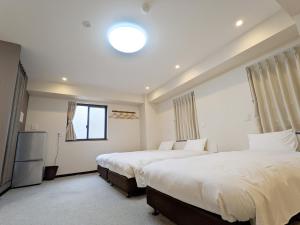 Vuode tai vuoteita majoituspaikassa KYU KYU HOTEL