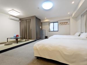 Vuode tai vuoteita majoituspaikassa KYU KYU HOTEL