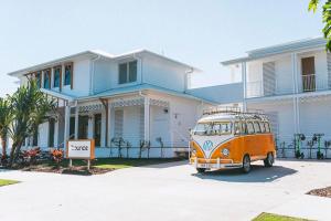 an orange van parked in front of a house at Bounce Noosa in Noosaville