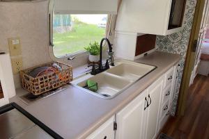 a kitchen counter with a sink and a window at Amazing Airstream, Beaufort, SC-Enjoy the Journey in Beaufort