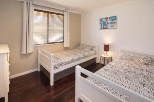 a bedroom with two beds and a window at Down Town Margaret River in Margaret River Town