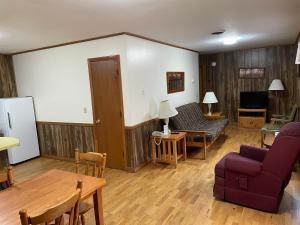 a living room with a couch and a table at PINE VALLEY MOTEL in Spruce Pine