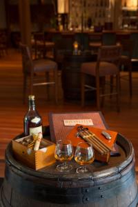a table with a bottle of wine and wine glasses at Kuramathi Maldives in Rasdu