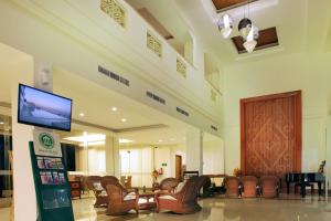 a lobby with chairs and a flat screen tv at Hotel on The Rock in Kupang