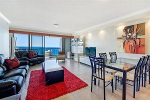 a living room with a couch and a table at Deluxe Chevron Renaissance in Gold Coast