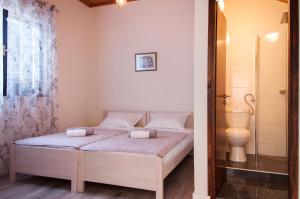 a bedroom with a bed and a shower and a toilet at Domus Albus in Zadar