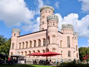 a large building with people sitting in front of it at Ferienwohnungen zum Neuensiener See P in Lancken-Granitz +47 photos