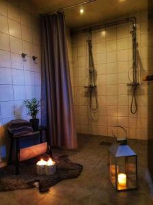 a bathroom with a shower and candles in a room at Villa Vasa Sälen Nedre lägenhet in Transtrand