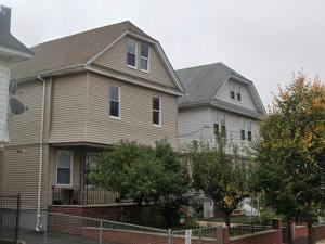 a couple of houses with a fence in front of them at Delightful well located one bedroom attic in Elizabeth