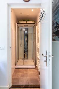 a walk in shower in a bathroom with a glass door at Koepel Enschede in Enschede