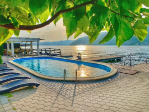 a large swimming pool next to a body of water at Exclusive in Eşelniţa