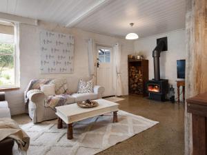 a living room with a couch and a stove at Edessa Lodge in Glenlyon