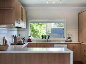 a kitchen with a sink and a large window at Della Fonte in Daylesford