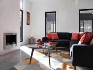 a living room with a couch and a table at Arenas North - 2 bedroom dog friendly home in Daylesford