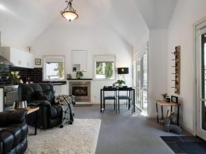a living room with a couch and a table at Cottage 4A in Daylesford