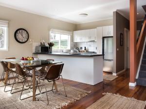 a kitchen and dining room with a table and chairs at Accolade in Daylesford