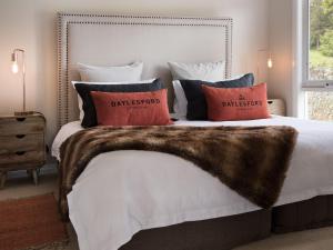 a bedroom with a bed with a fur blanket and pillows at Accolade in Daylesford