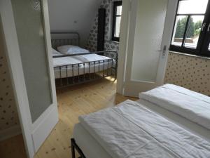 a bedroom with two beds and a mirror at Großes Ferienhaus in Graal-Müritz in Graal-Müritz