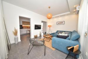 a living room with a blue couch and a table at Villa Teuta ZadarVillas in Zadar
