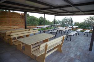 a group of tables and benches on a patio at Apartmaji Hočka Koča in Hočko Pohorje