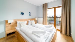Posteľ alebo postele v izbe v ubytovaní Apartamenty Sun & Snow Resort Karkonosze
