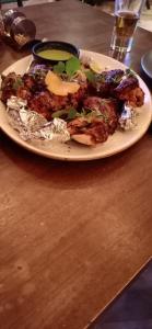 a plate of food on a wooden table at Parvi Homestay in Darjeeling