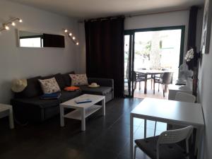 a living room with a couch and a table at Departamento Barcaro 2 in Puerto del Carmen