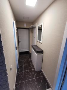 a bathroom with a toilet and a tile floor at ALDO comfort in Ludza