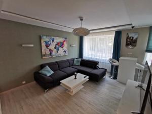 a living room with a couch and a table at ALDO comfort in Ludza