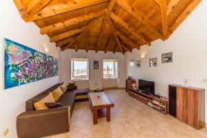 a living room with a couch and a tv at Apartments Casa Vanna in Dubrovnik