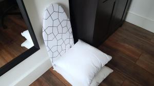 a white pillow in a room with a mirror at The Hide Away Modern Rooms in Norwood