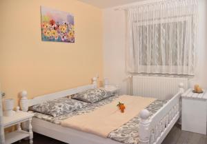 a bedroom with a white bed with a table on it at Gostišče Trobej in Gornji Grad