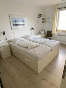 a bedroom with a bed and a desk and a window at Ferienwohnung Fichtenweg in Winterberg