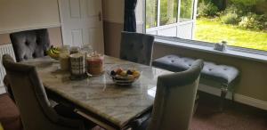 a dining room table with a bowl of fruit on it at Peaceful Place in Mansfield