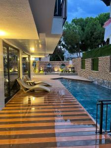 a swimming pool in the middle of a house at Estera Hotel Silent in Antalya