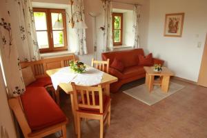 a living room with a table and a couch at Ferienwohnung Fritzenwenger in Übersee +37 photos