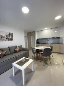a living room with a couch and a table at Panorama apartments in Veliko Gradište