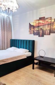 a bedroom with a bed and a table at Apartment Lenina in Vladimir