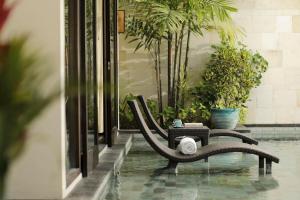 a bench sitting in the middle of a pool at The Seminyak Beach Resort & Spa in Seminyak