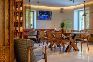 a dining room with a table and chairs at Villa Pinia Eco-hotel in Odesa