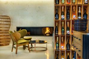 a room with a fireplace and a wall of wine bottles at Villa Pinia Eco-hotel in Odesa